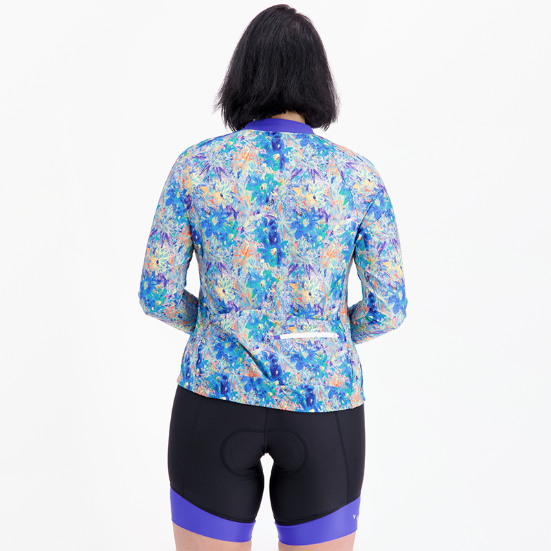 back view of blue artsy floral long sleeve bicycle jersey with zip pocket